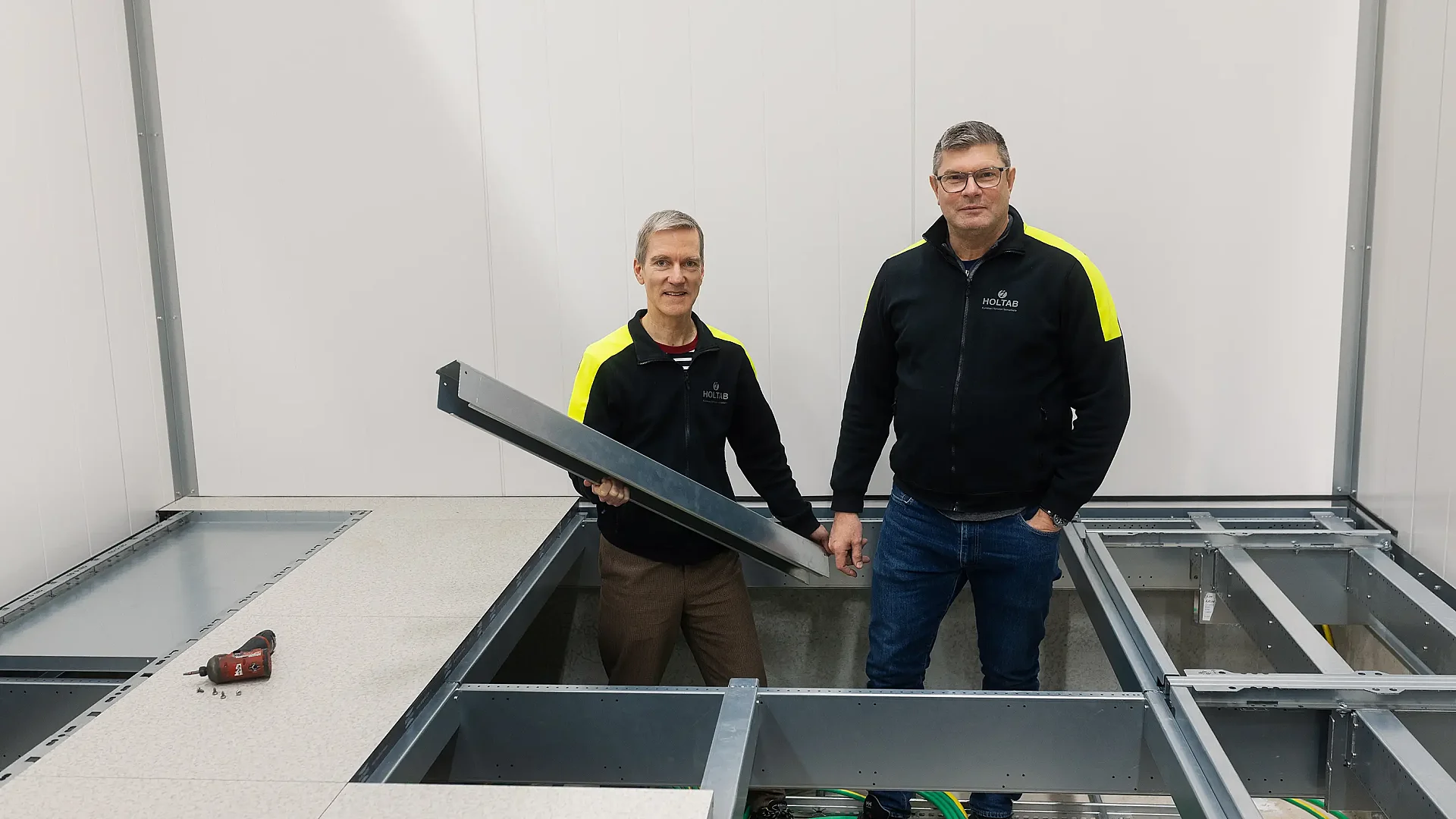 Two Holtab employees in a technical building