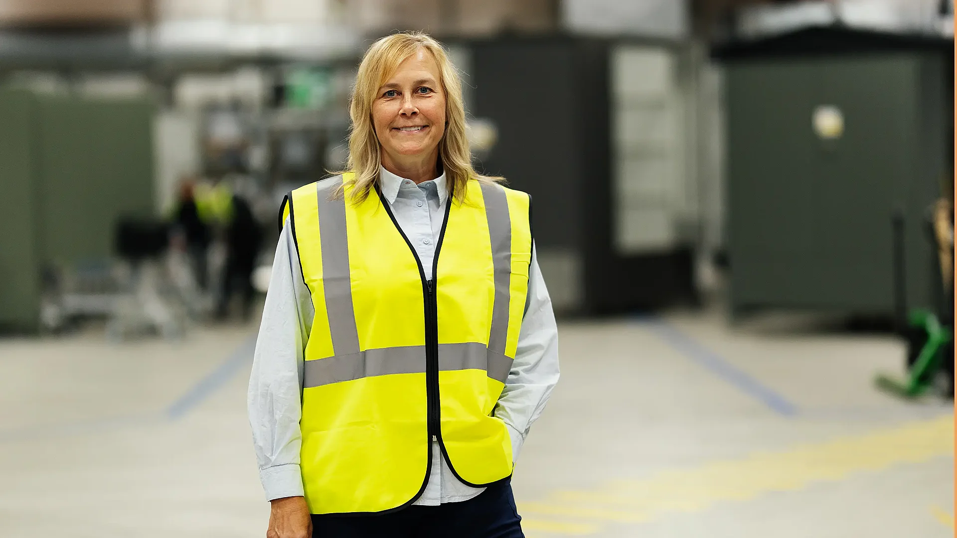 Smiling woman in front of secondary substations