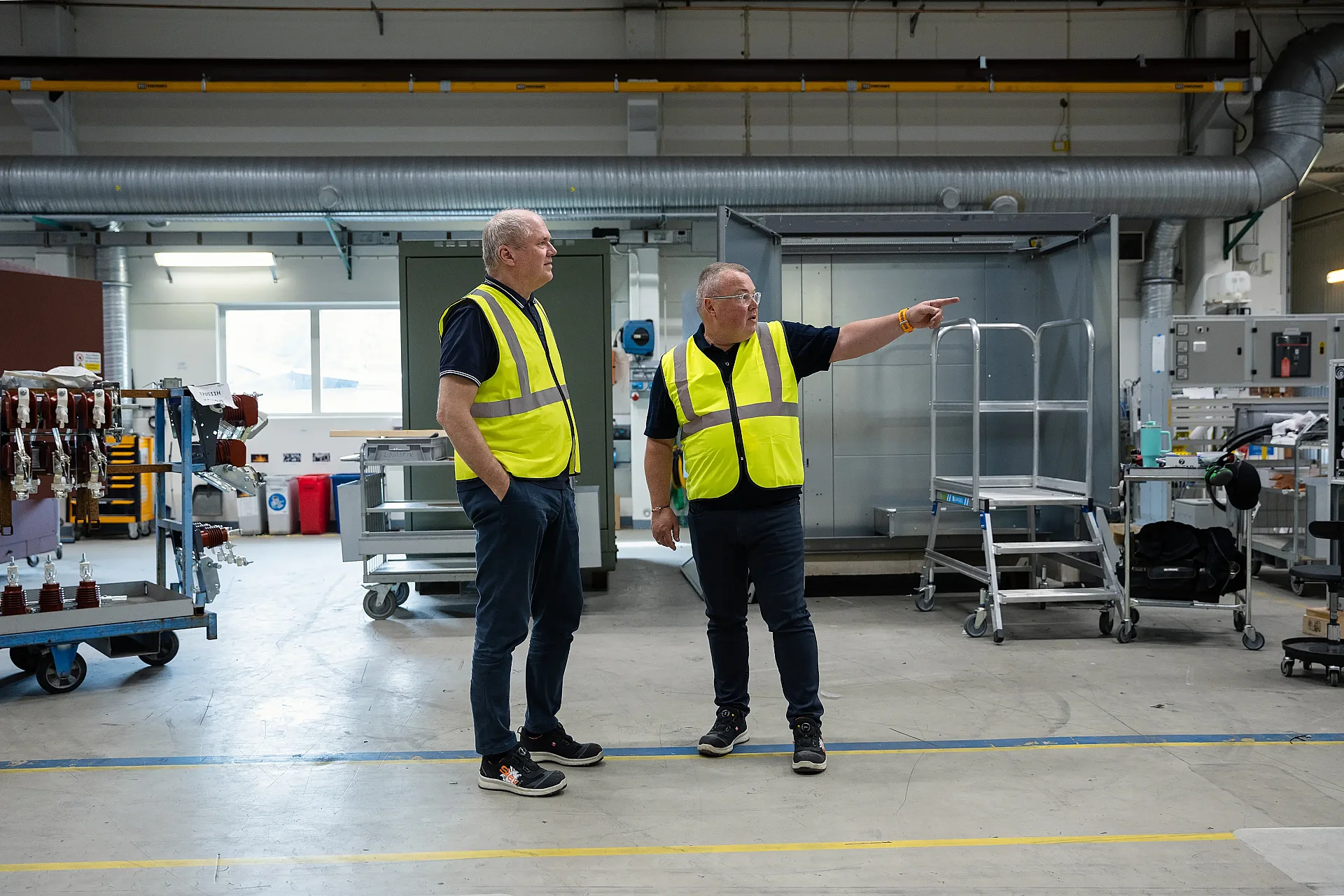Two persons together in production area.